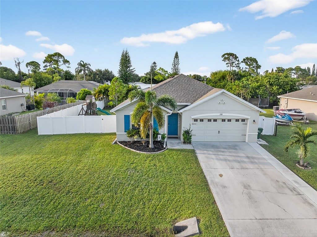 233 Periwinkle Drive Sebastian, FL 32958 - Photo 34 of 34 a view of house with garden and tall trees