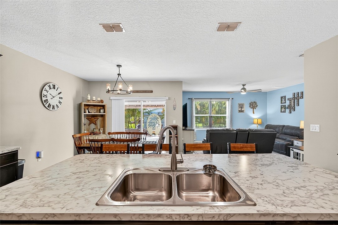 233 Periwinkle Drive Sebastian, FL 32958 - Photo 8 of 34 a view of kitchen center with granite countertop living room