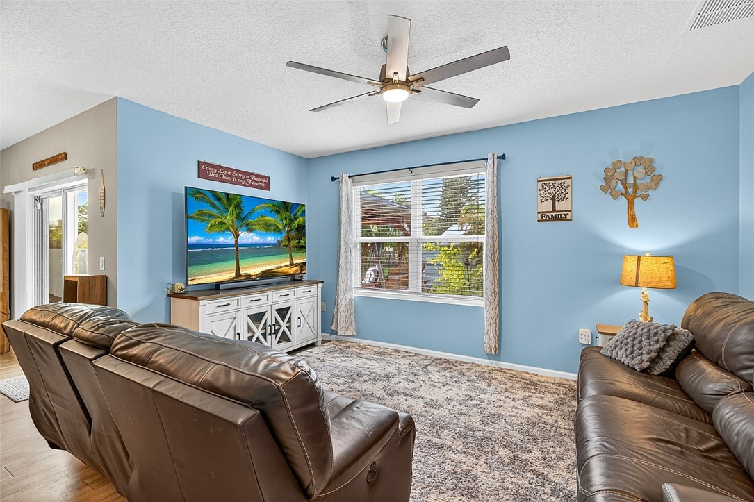 233 Periwinkle Drive Sebastian, FL 32958 - Photo 10 of 34 a living room with furniture and a flat screen tv