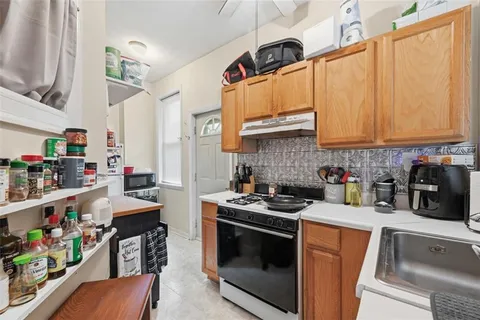 a kitchen with stainless steel appliances granite countertop a stove and cabinets