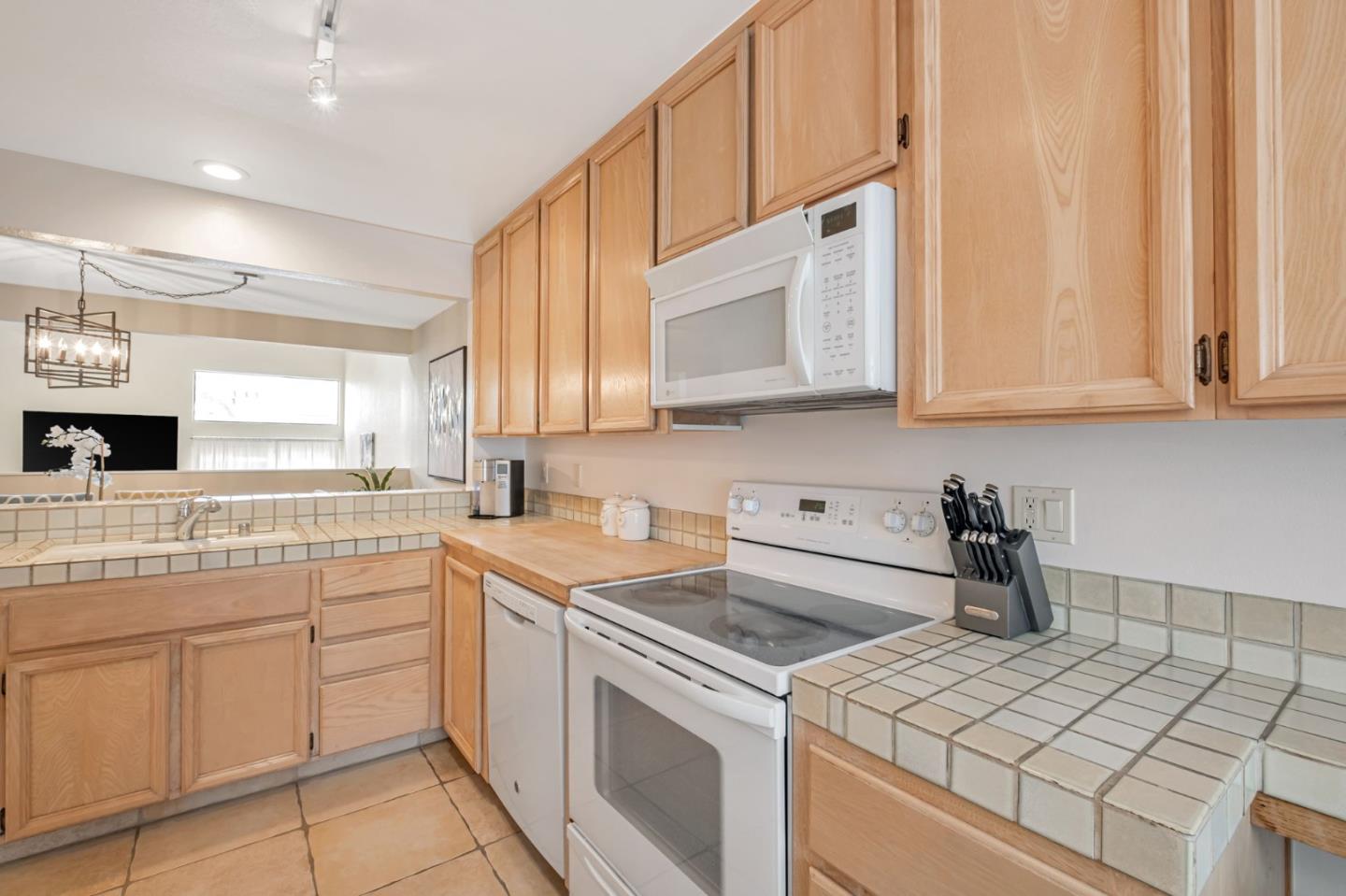 1067 Vía Tornasol Aptos, CA 95003 - Photo 11 of 38 a kitchen with appliances cabinets and a sink