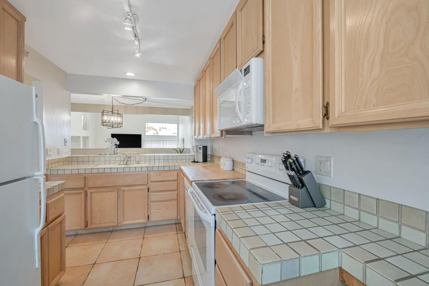 1067 Vía Tornasol Aptos, CA 95003 - Photo 12 of 38 a kitchen with a sink and cabinets