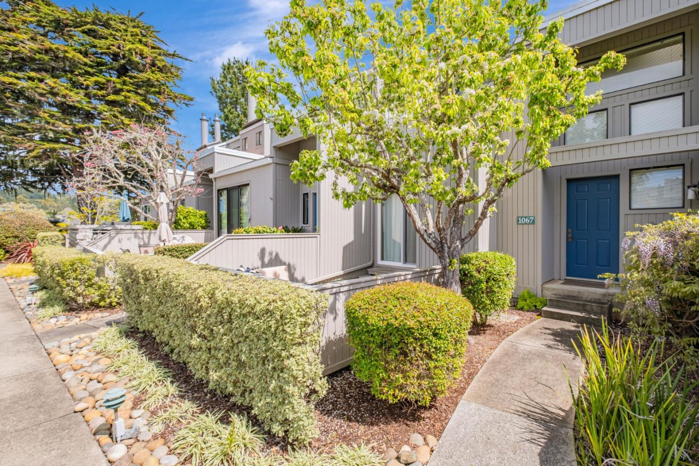 1067 Vía Tornasol Aptos, CA 95003 - Photo 2 of 38 a front view of a house with garden