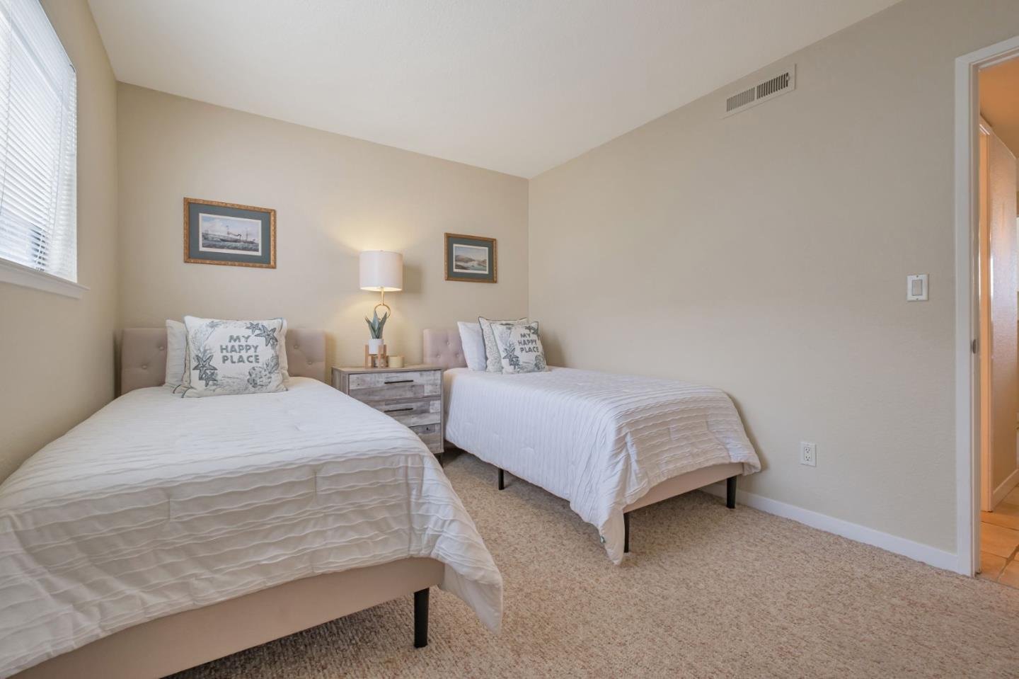 1067 Vía Tornasol Aptos, CA 95003 - Photo 22 of 38 a bedroom with a bed and a night stand