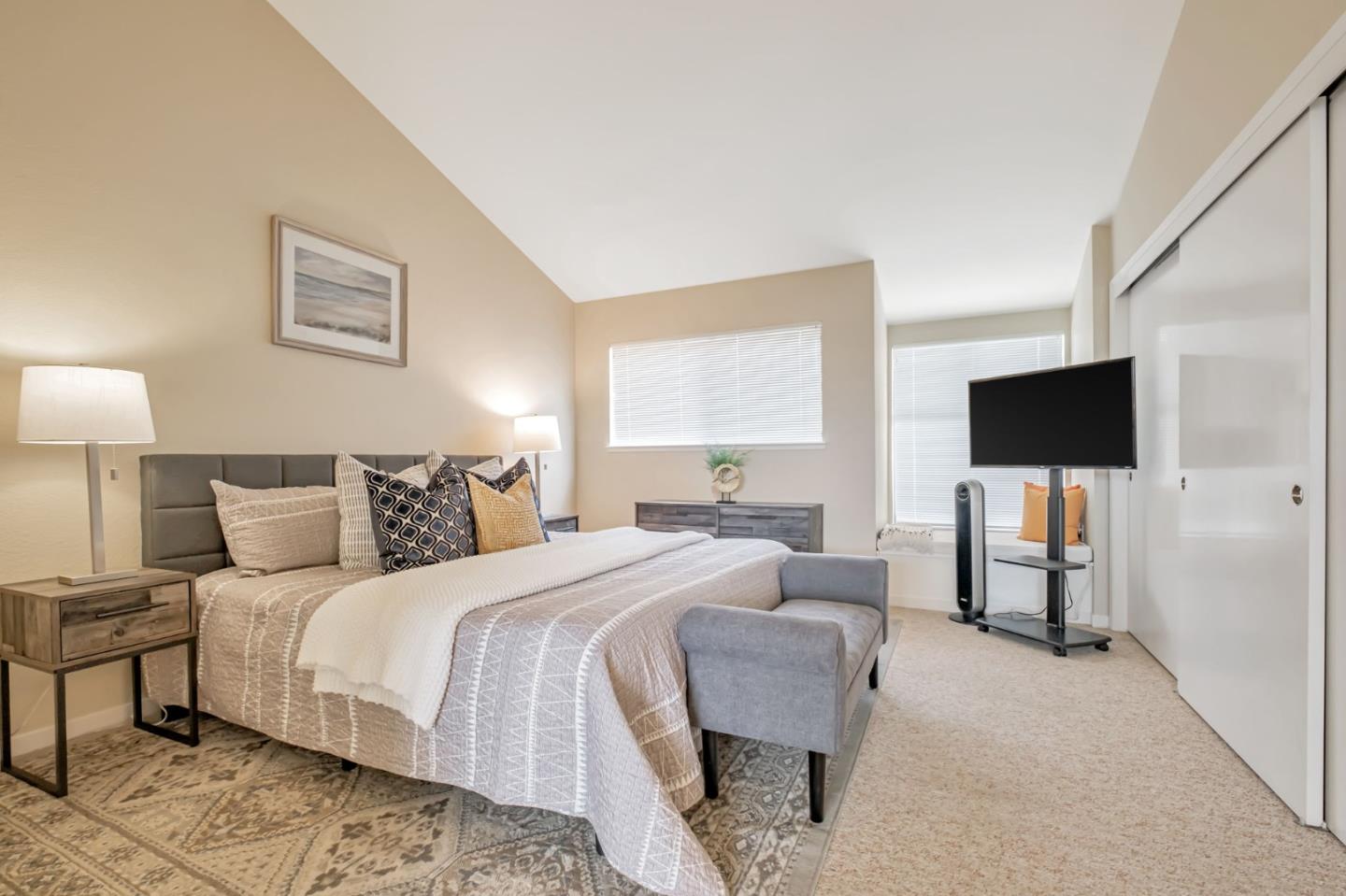 1067 Vía Tornasol Aptos, CA 95003 - Photo 26 of 38 a bedroom with a bed and a flat screen tv