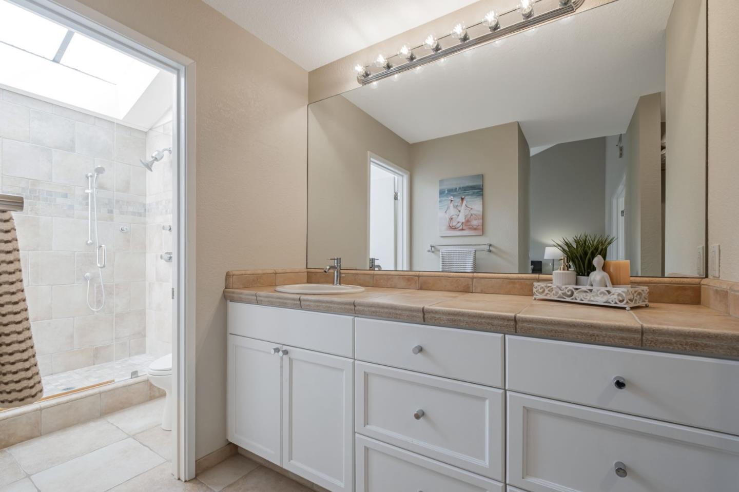 1067 Vía Tornasol Aptos, CA 95003 - Photo 28 of 38 a bathroom with a granite countertop sink mirror and double