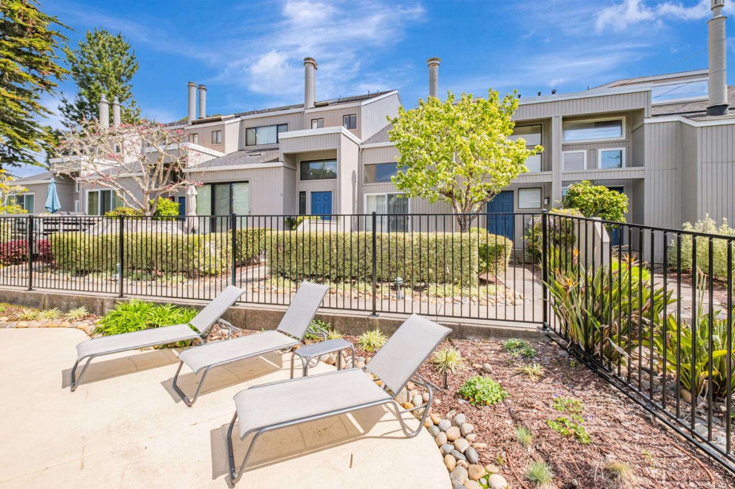 1067 Vía Tornasol Aptos, CA 95003 - Photo 35 of 38 a view of a patio with couches table and chairs and potted plants