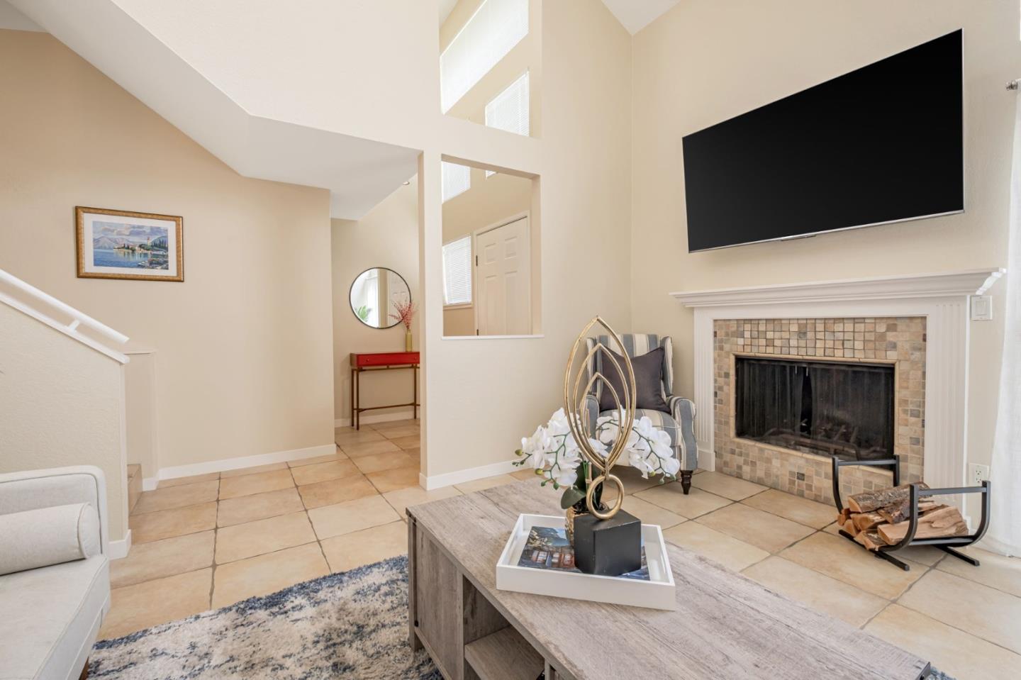 1067 Vía Tornasol Aptos, CA 95003 - Photo 8 of 38 a living room with furniture a flat screen tv and a fireplace