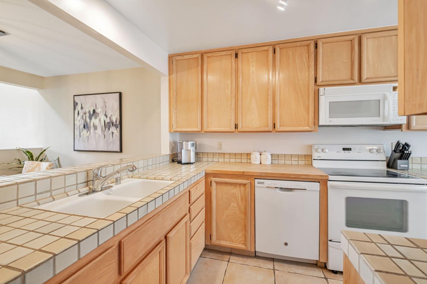 1067 Vía Tornasol Aptos, CA 95003 - Photo 9 of 38 a kitchen with a sink stove and cabinets