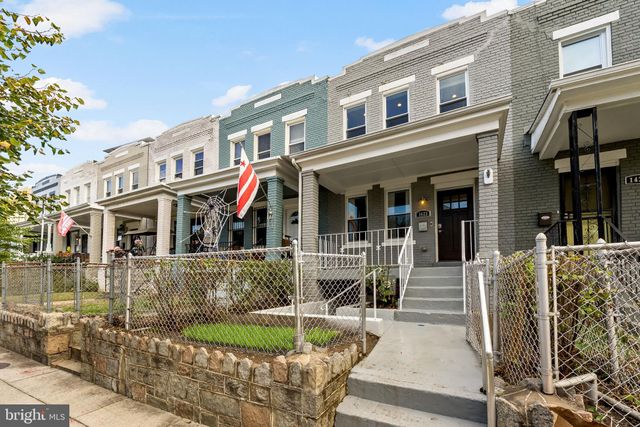 a view of a kitchen with wooden floor and a ceiling fan