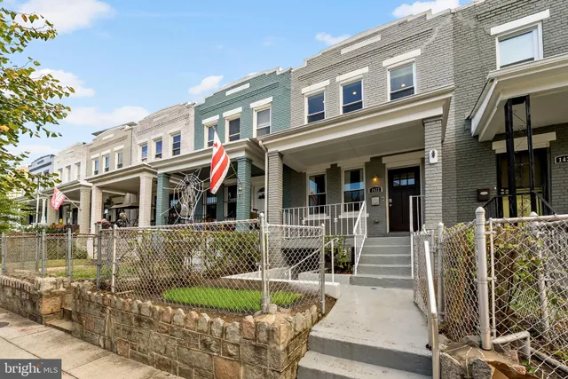 a view of a kitchen with wooden floor and a ceiling fan