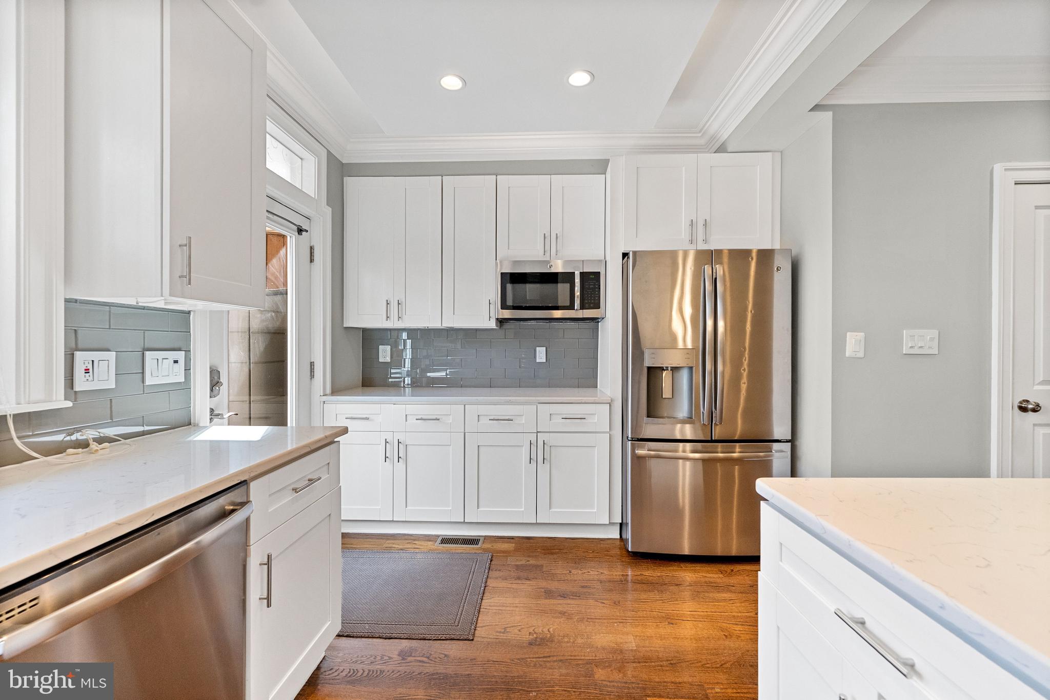 1423 Montello Avenue Northeast Washington, DC 20002 - Photo 15 of 30 a kitchen with white cabinets and stainless steel appliances
