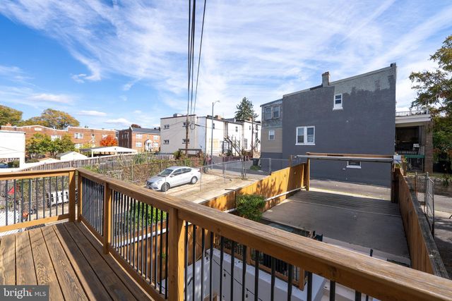 a view of a hallway with wooden floor and a cabinet