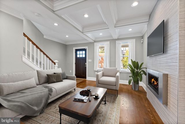 a living room with furniture fireplace and flat screen tv