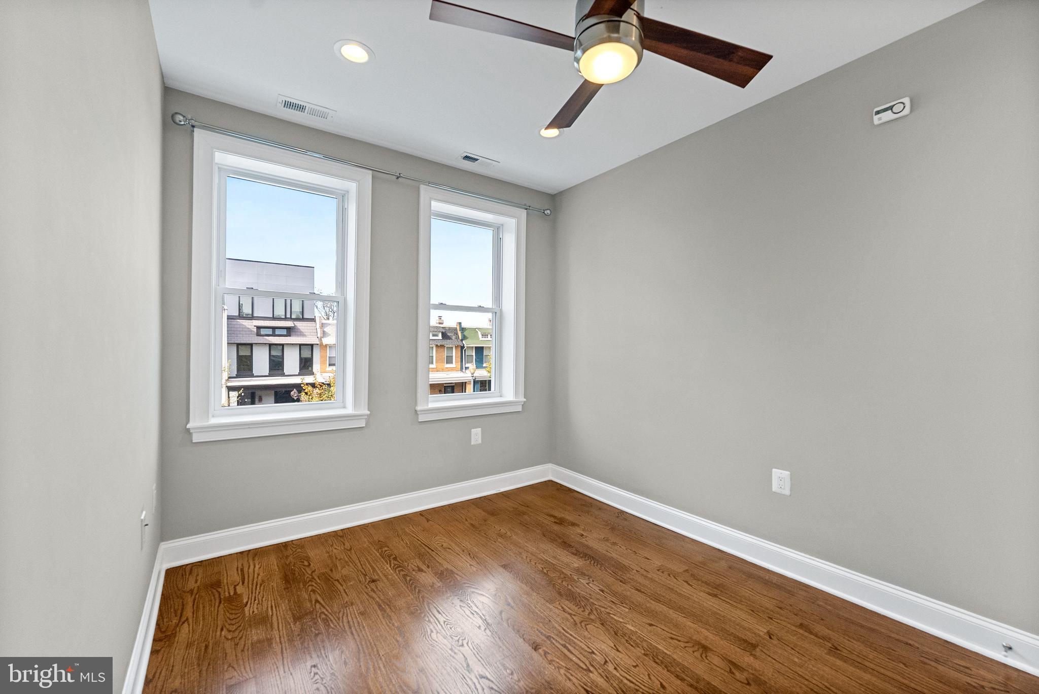 1423 Montello Avenue Northeast Washington, DC 20002 - Photo 22 of 30 wooden floor in an empty room with a window