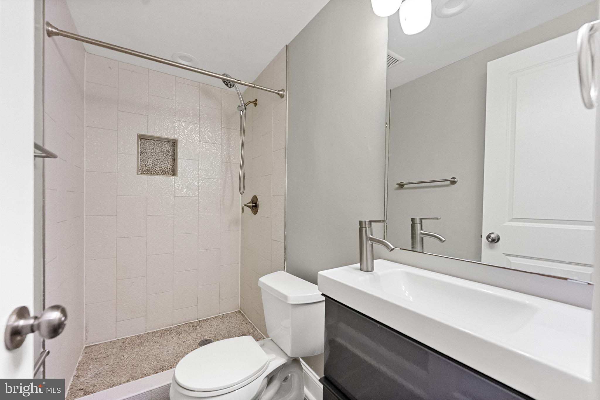 1423 Montello Avenue Northeast Washington, DC 20002 - Photo 25 of 30 a bathroom with a sink a toilet and shower