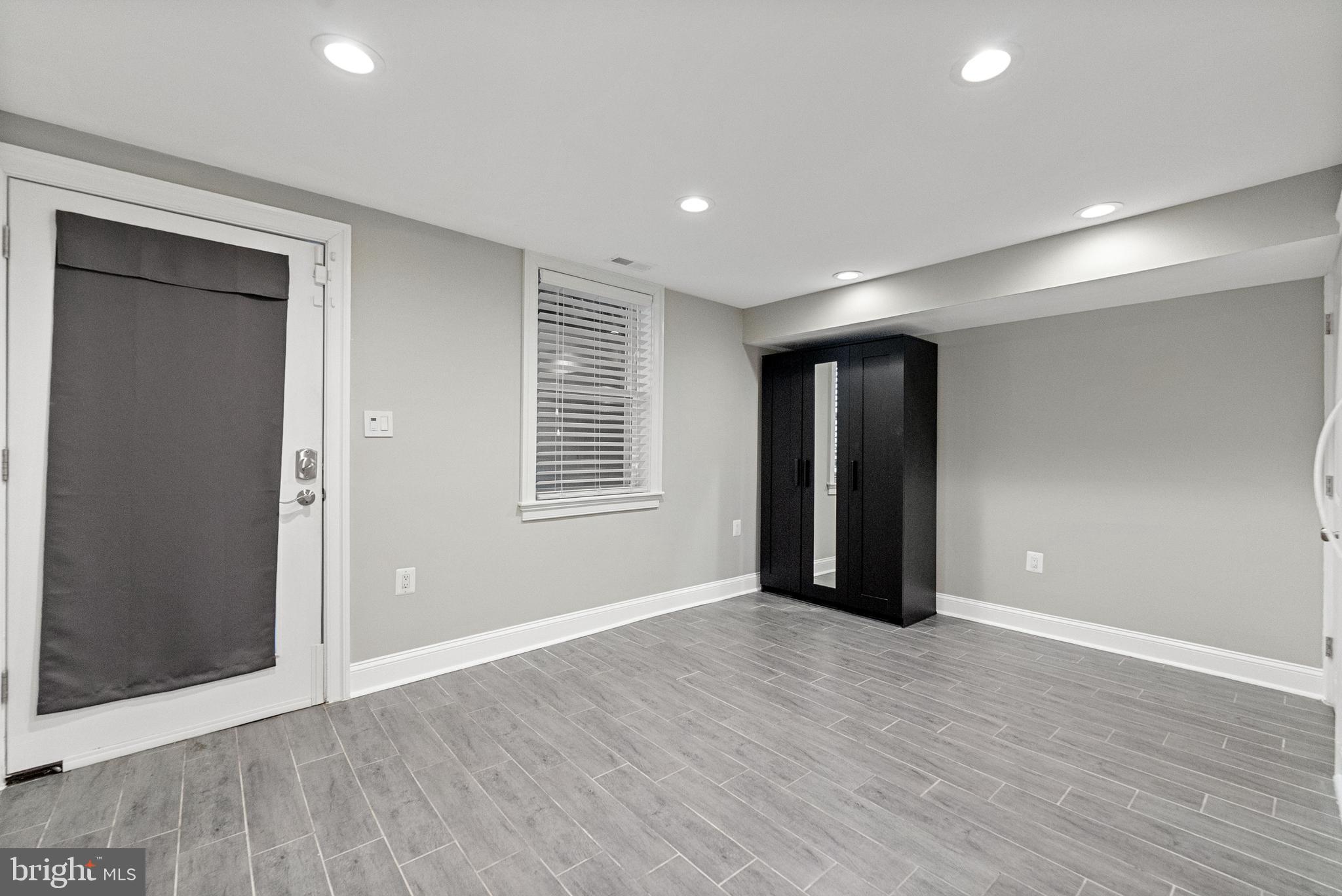 1423 Montello Avenue Northeast Washington, DC 20002 - Photo 26 of 30 a view of an empty room with wooden floor and windows