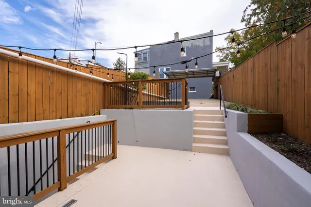 a view of house with roof deck and furniture