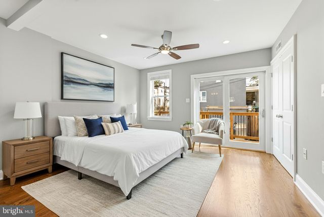 a bedroom with a large bed and a large window