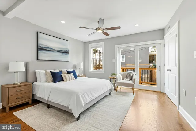 a bedroom with a large bed and a large window