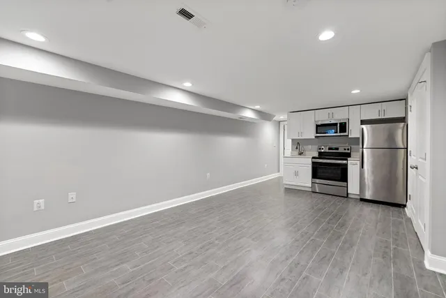 a view of kitchen wooden floor and electronic appliances