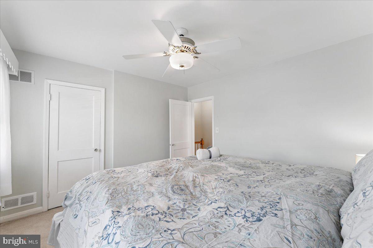 7024 Conley Street Baltimore, MD 21224 - Photo 11 of 20 a bedroom with a large bed and a chandelier