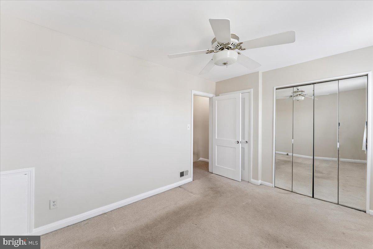 7024 Conley Street Baltimore, MD 21224 - Photo 15 of 20 a view of a room with a ceiling fan and a window