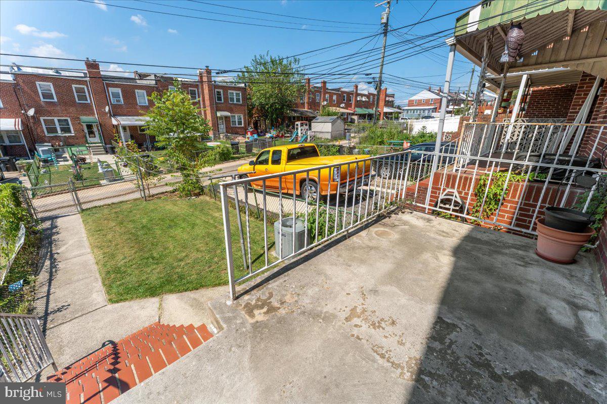 7024 Conley Street Baltimore, MD 21224 - Photo 20 of 20 a view of a balcony with a floor to ceiling window and potted plants