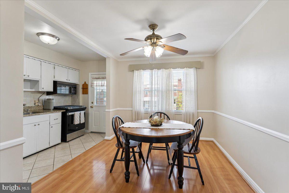 7024 Conley Street Baltimore, MD 21224 - Photo 6 of 20 a view of a dining room with furniture window and wooden floor
