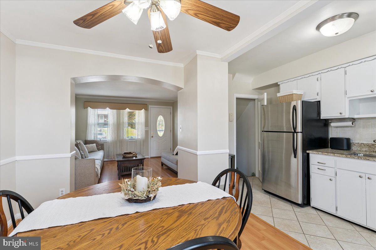 7024 Conley Street Baltimore, MD 21224 - Photo 7 of 20 a kitchen with stainless steel appliances refrigerator dining table and chairs