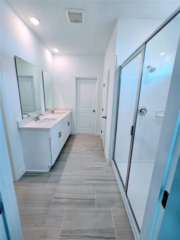 a bathroom with a double vanity sink and a mirror