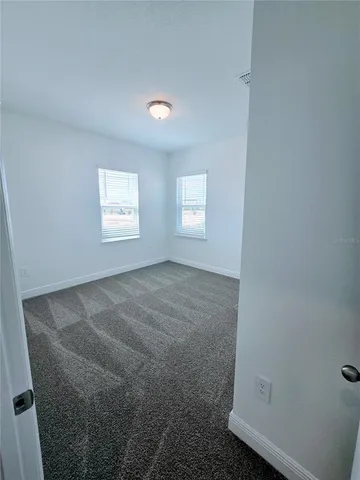 a spacious bathroom with a double vanity sink toilet mirror and shower