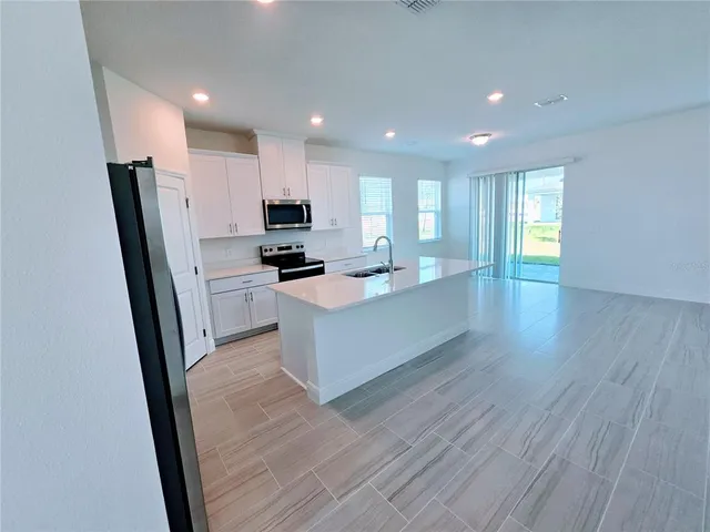 a view of kitchen view wooden floor wooden floor and kitchen view