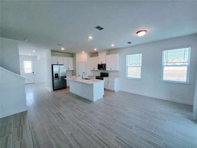 a kitchen with appliances a sink and cabinets