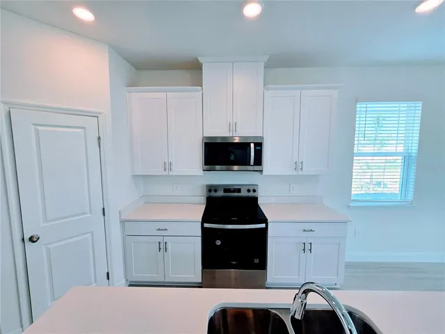 a view of a livingroom with an empty room and wooden floor