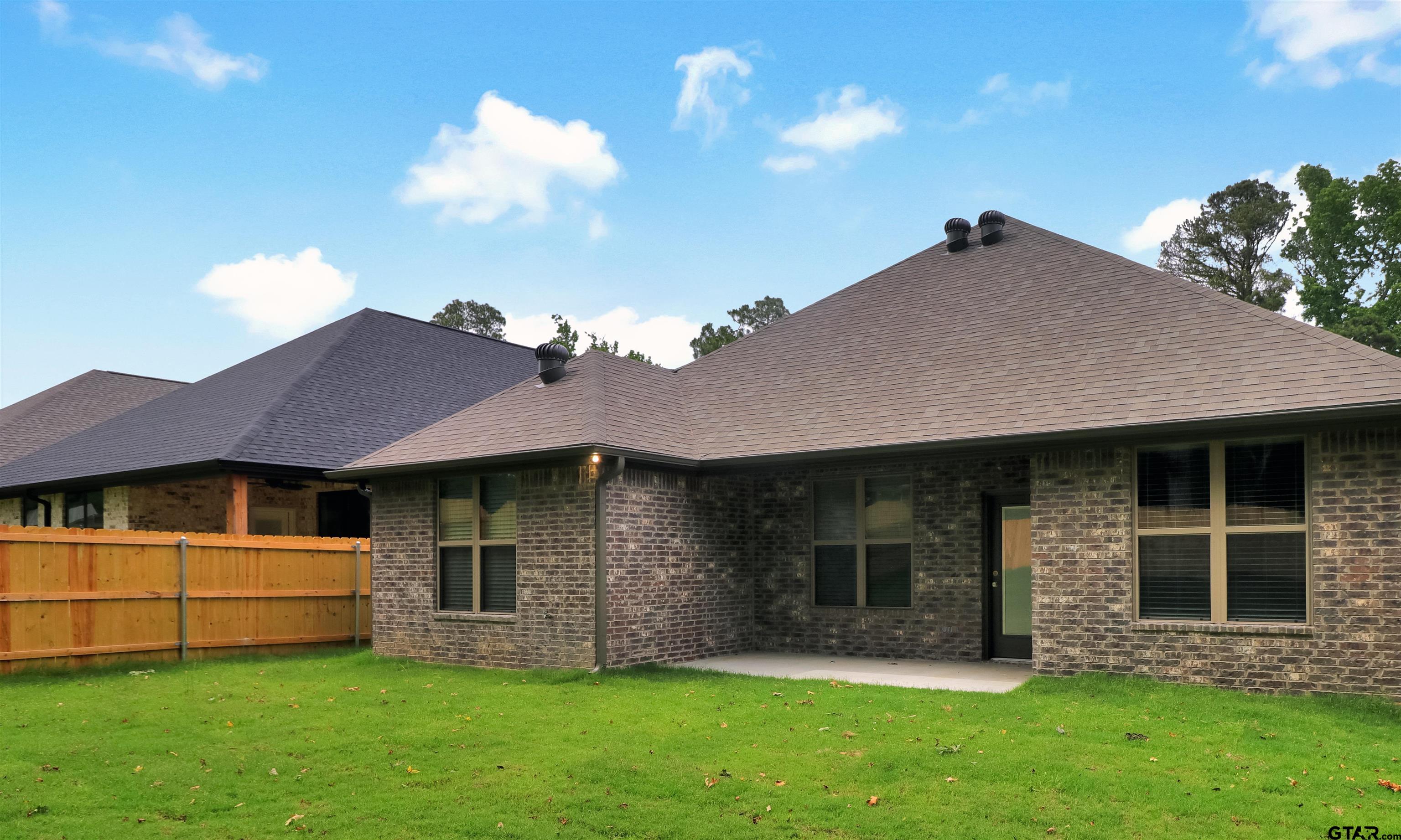 3057 Guinn Farms Road Tyler, TX 75707 - Photo 27 of 32 a front view of a house with a garden and yard