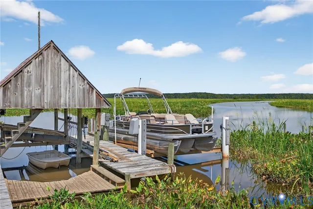 a view of a chairs and table in patio with a lake view