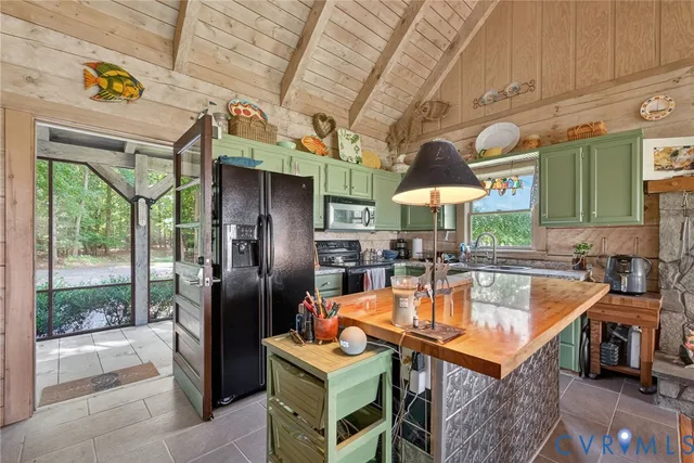 a kitchen with stainless steel appliances granite countertop a sink a stove and a refrigerator