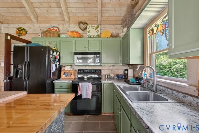 a kitchen with stainless steel appliances granite countertop a sink and a refrigerator