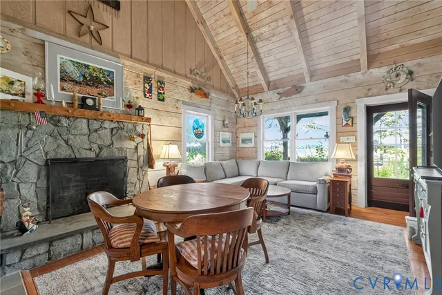a dining room with furniture a fireplace and wooden floor