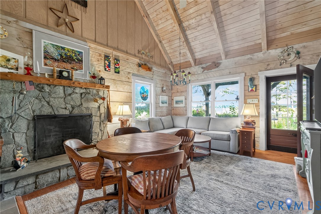 21407 Old Neck Road Charles City, VA 23030 - Photo 26 of 50 a dining room with furniture a fireplace and wooden floor