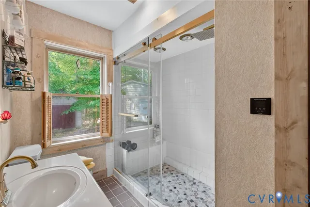 a bathroom with a sink toilet and shower