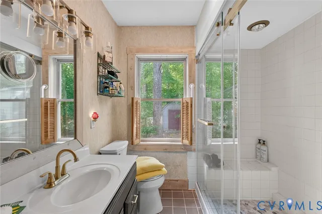 a bathroom with a sink toilet a mirror and tub