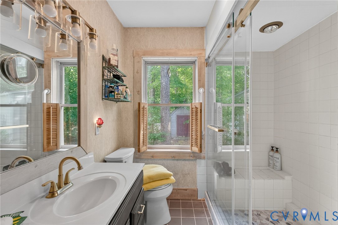 21407 Old Neck Road Charles City, VA 23030 - Photo 30 of 50 a bathroom with a sink toilet a mirror and tub