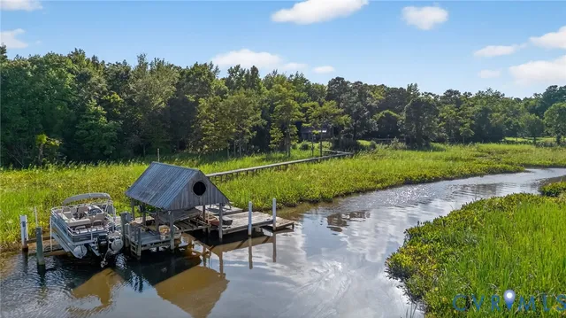 an aerial view of a house with garden space and lake view