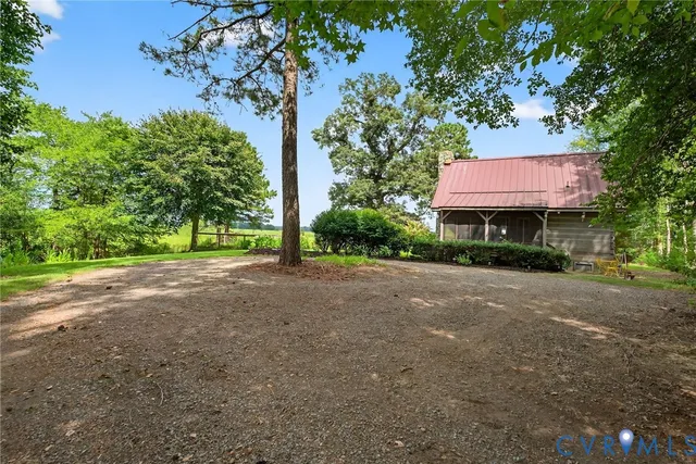 a view of a street with a large trees