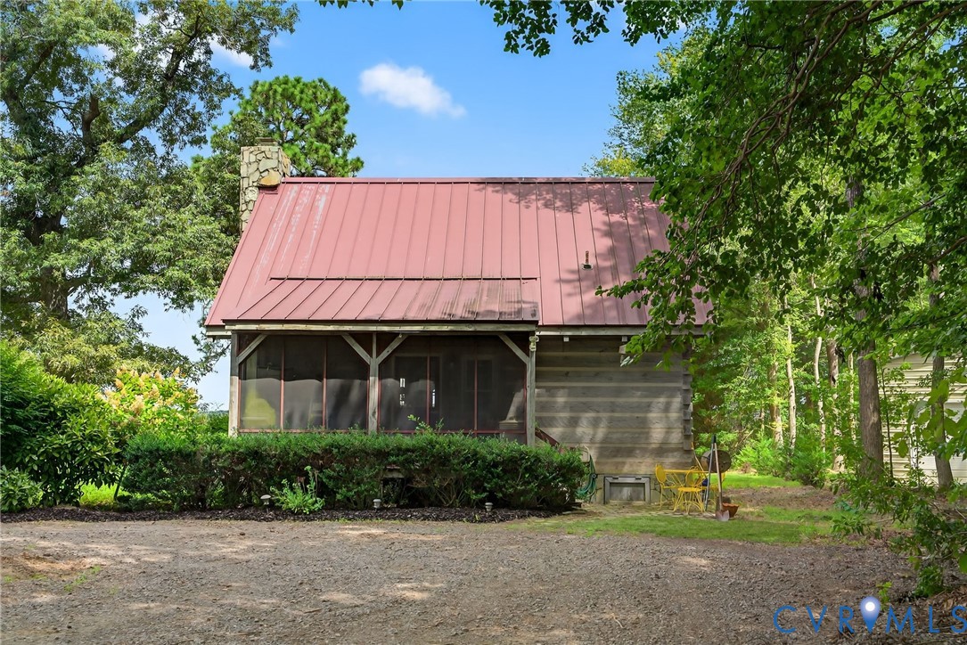 21407 Old Neck Road Charles City, VA 23030 - Photo 44 of 50 a backyard of a house with outdoor seating and trees