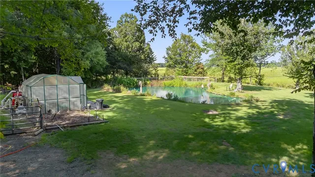 a view of a playground with a lake view and a bench