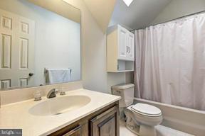 1901 Ednor Road Silver Spring, MD 20905 - Photo 22 of 30 a bathroom with a sink a toilet and shower curtain