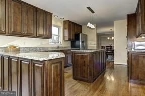 1901 Ednor Road Silver Spring, MD 20905 - Photo 8 of 30 a kitchen with granite countertop a sink a stove and cabinets